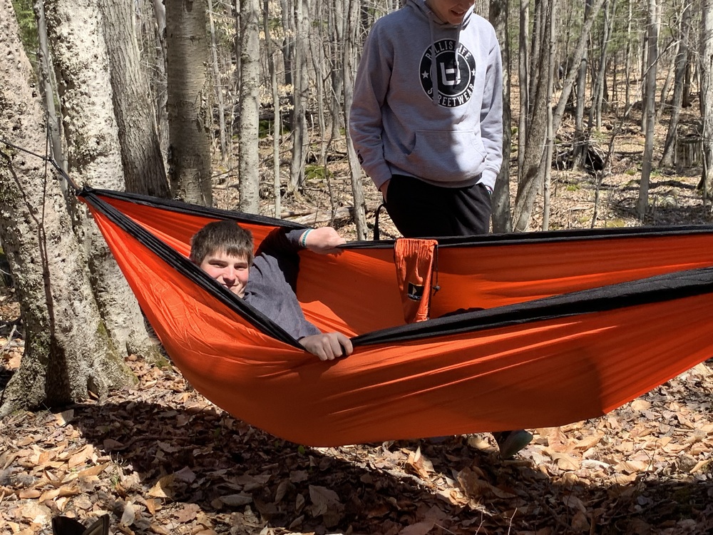 Teenage boy in an orange hammock 