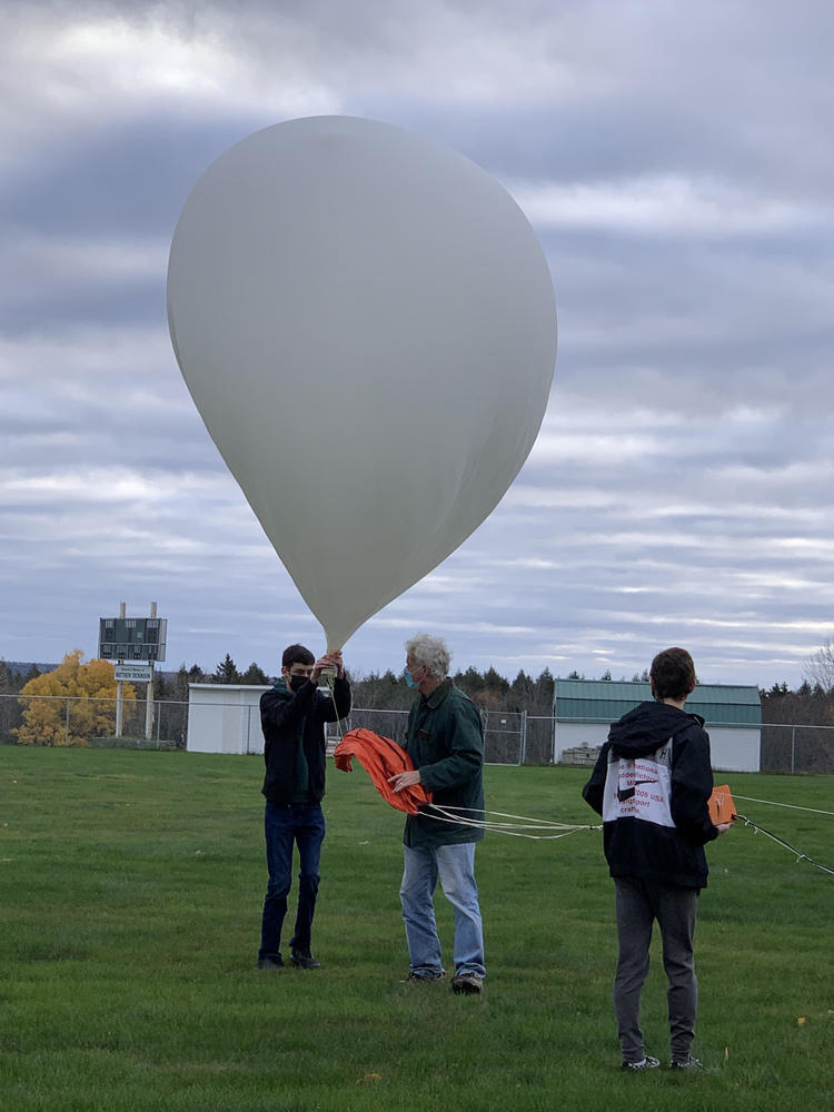 Stem class launching weather balloon outdoors